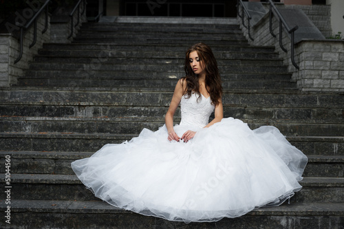 Photo: beautiful young woman in wedding dress beautiful young woman in wedding dress