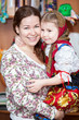 Photo: Happy mother holding small girl in Russian traditional clothes Happy mother holding small girl in Russian traditional clothes