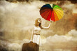 Beautifu girl with umbrella and suitcase at sky background.