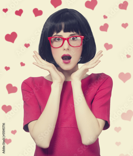 Photo: girl in red glasses at white background. girl in red glasses at white background.