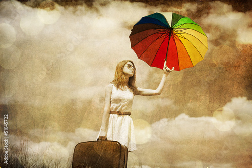 Photo: Beautifu girl with umbrella and suitcase at sky background. Beautifu girl with umbrella and suitcase at sky background.