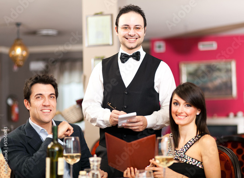 Photo: Waiter serving a couple Waiter serving a couple