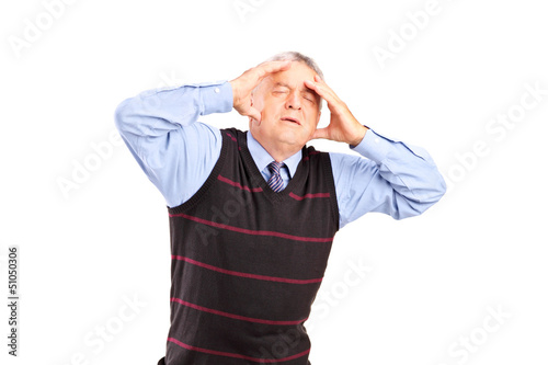 Photo: A mature man holding his head in pain A mature man holding his head in pain