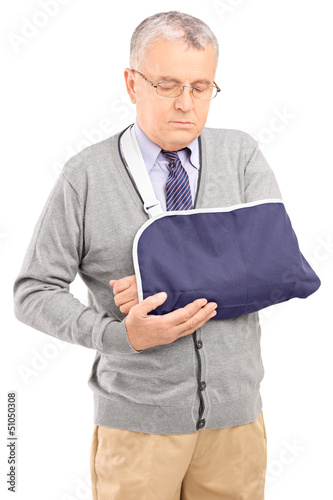 Photo: A senior man with a broken arm posing A senior man with a broken arm posing