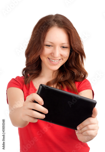 Photo: Young woman playing games on tablet Young woman playing games on tablet