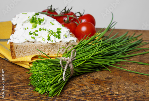 Photo: a bunch of fresh chives and a bread with cottage cheese a bunch of fresh chives and a bread with cottage cheese