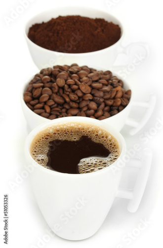 Photo: Different types of coffee in three cups isolated on white Different types of coffee in three cups isolated on white