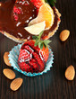 Fruit in chocolate against a dark background