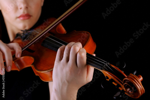Photo: Musician playing violin on black background Musician playing violin on black background