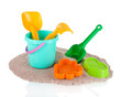 Children\'s toys on sand isolated on white