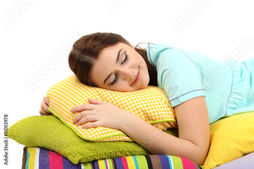 Photo: Beautiful young girl with pillows isolated on white. Beautiful young girl with pillows isolated on white.