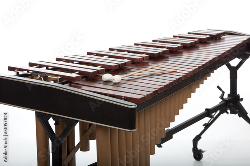 Photo: A brown wooden marimba on a white background A brown wooden marimba on a white background
