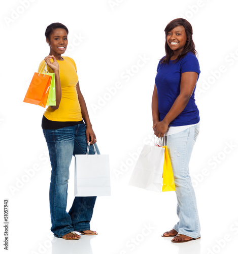 Photo: Two young African American friends with shopping bags Two young African American friends with shopping bags