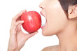 young woman eating red apple with health teeth