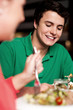 Handsome young guy enjoying meal in restaurant