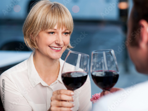 Photo: Couple toasting in a restaurant Couple toasting in a restaurant