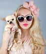 Beautiful woman with chihuahua in hands