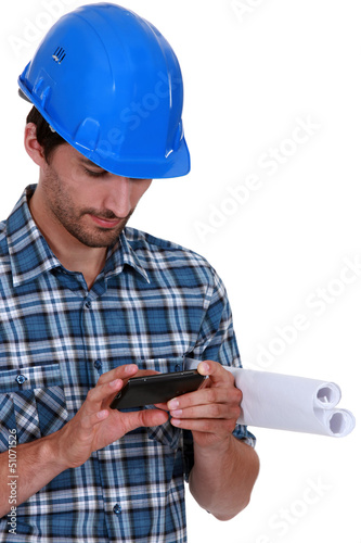Photo: Architect sending text message Architect sending text message