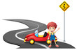 A young boy near a yellow signage with his car