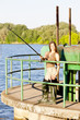 Photo: young woman fishing at pond young woman fishing at pond