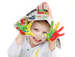 Cute little boy is proud of his coloured hands