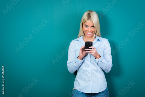 Photo: junge frau liest mit freude eine sms junge frau liest mit freude eine sms