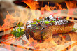 grilled steak with flames