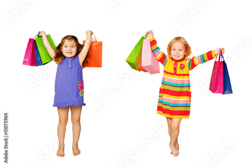 Photo: Kids shopping. Two little girls with their purchases and gifts. Kids shopping. Two little girls with their purchases and gifts.