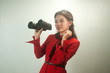 Pretty Asian business woman holding  binoculars.