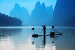 Chinese man fishing with cormorants birds, Yangshuo, Guangxi reg