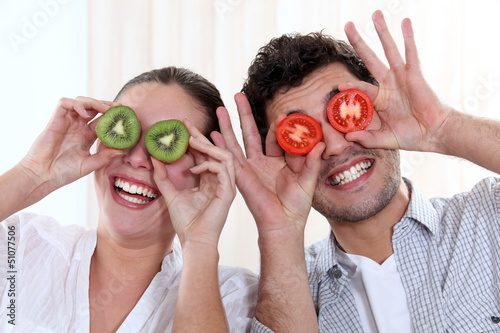 Photo: Funny couple covering their eyes with fruit Funny couple covering their eyes with fruit