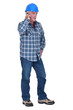 Senior construction worker making call to colleague