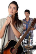 brunette with microphone rehearsing