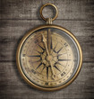 old brass compass on wood table top view