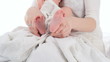 Pink baby feet in mother's hands