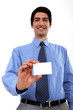 businessman with toothy smile showing business card