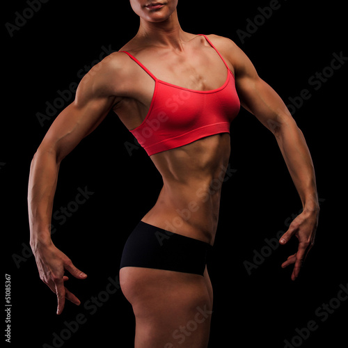 Photo: Muscular strong woman on a black background Muscular strong woman on a black background