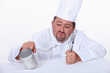 Chef poking tin can