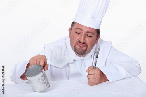Photo: Chef poking tin can Chef poking tin can