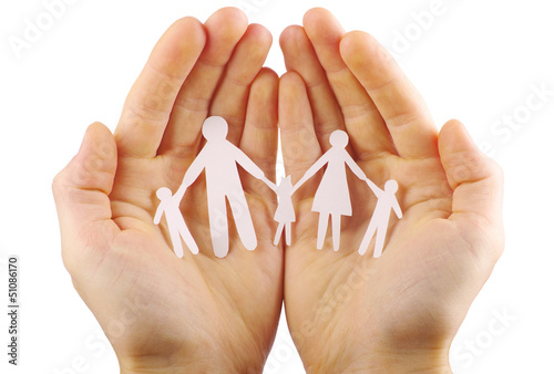 Photo: Paper family in hands isolated on white background Paper family in hands isolated on white background