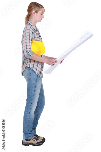 Photo: Woman holding building plans Woman holding building plans