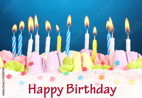 Photo: Birthday cake with candles on blue background Birthday cake with candles on blue background