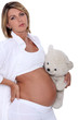 Pregnant woman with teddy bear