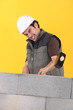 Worker hitting a wall with a sledgehammer