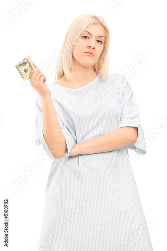 Photo: Female patient in a gown holding money Female patient in a gown holding money
