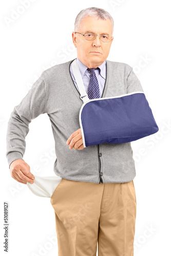 Photo: Poor man with broken arm showing his empty pocket Poor man with broken arm showing his empty pocket