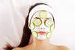 Young woman with cucumber slices on the face
