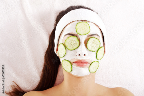 Photo: Young woman with cucumber slices on the face Young woman with cucumber slices on the face