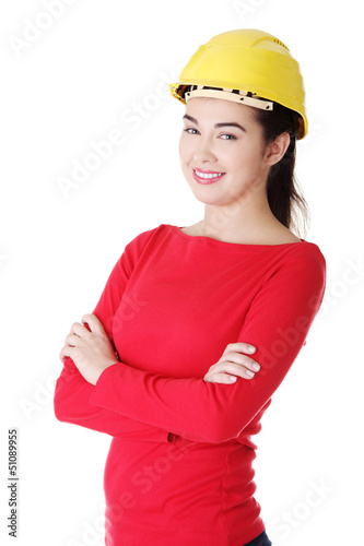 Photo: Portrait of confident female worker in helmet. Portrait of confident female worker in helmet.