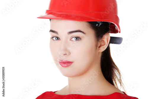 Photo: Portrait of confident female worker in helmet. Portrait of confident female worker in helmet.